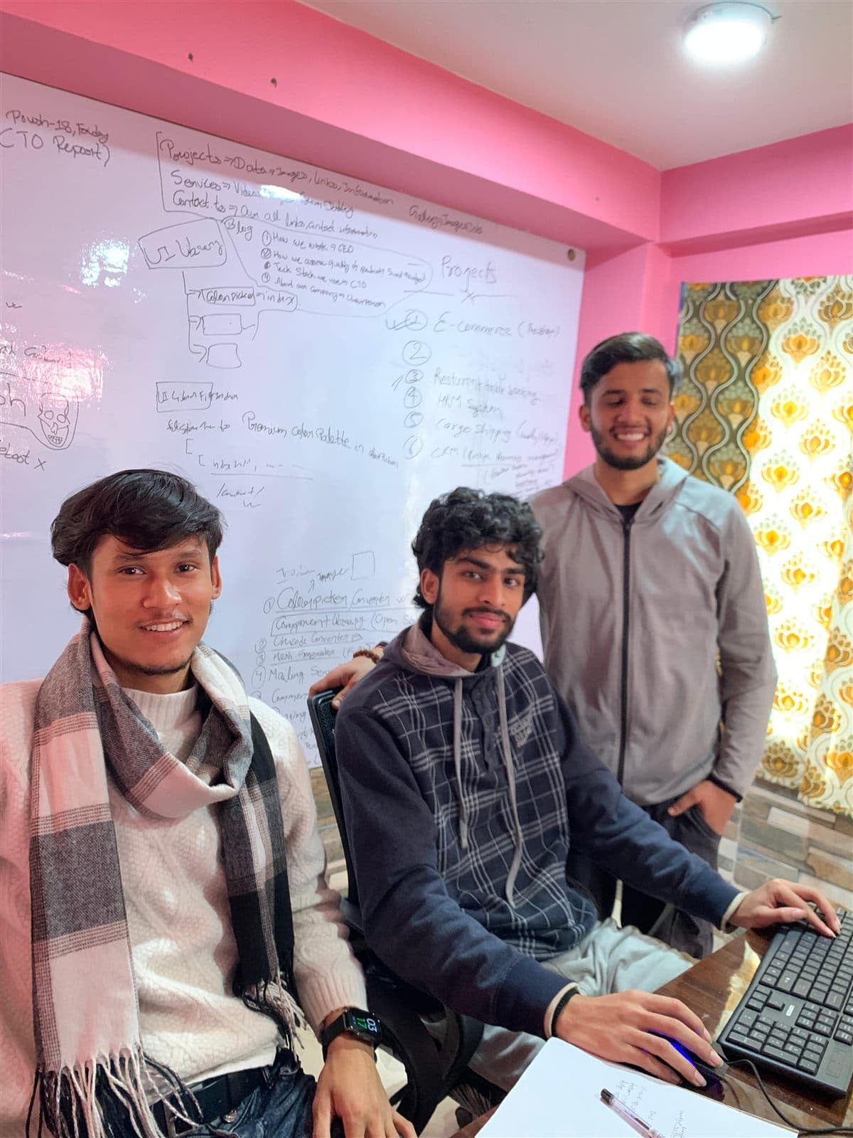Scarves indoors - The board is dated Poush 18. Butwal gets cold enough that month to keep a scarf on at the desk.